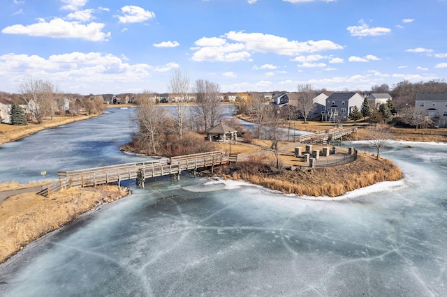 exterior space featuring a water view, fence, and a residential view