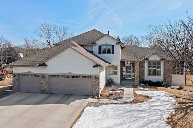 view of front of property featuring concrete driveway, brick siding, a garage, and roof with shingles