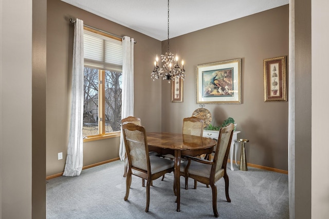 dining area with a notable chandelier, baseboards, and carpet floors