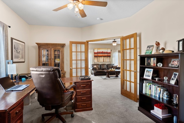 office space with french doors, a ceiling fan, and carpet