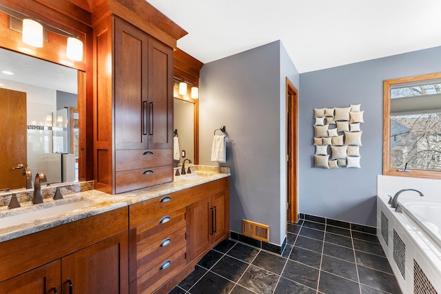 bathroom featuring double vanity, visible vents, tile patterned flooring, and a sink