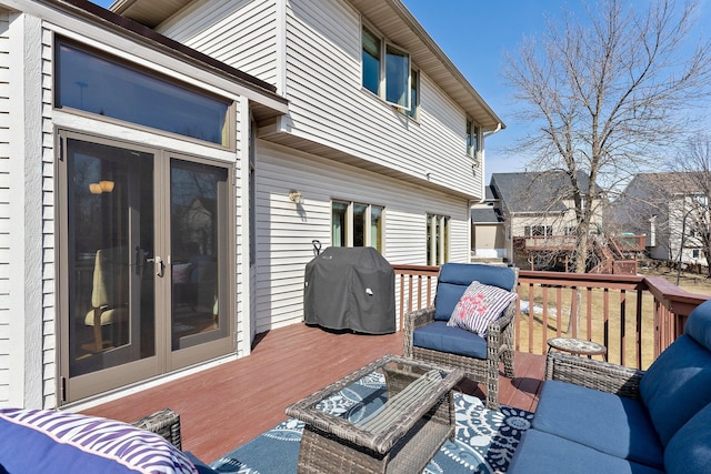 deck featuring an outdoor living space, a grill, and french doors