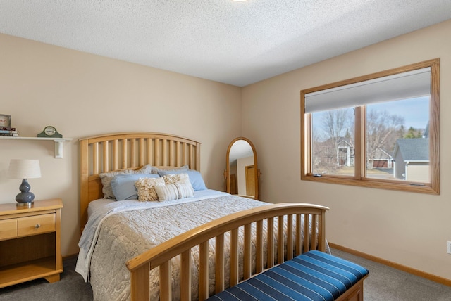 bedroom featuring baseboards, a textured ceiling, and carpet flooring