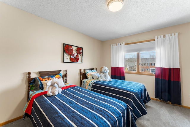 bedroom with carpet flooring, baseboards, and a textured ceiling