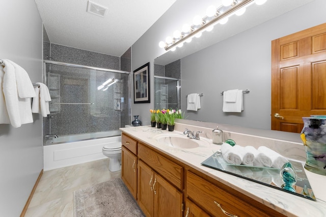 full bathroom featuring vanity, toilet, visible vents, and shower / bath combination with glass door