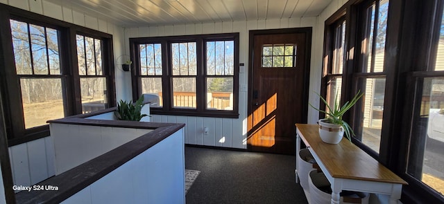 sunroom / solarium featuring wood ceiling