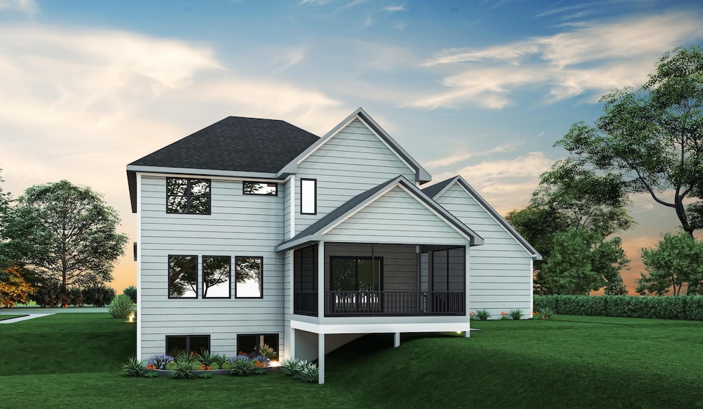 back of house featuring roof with shingles, a lawn, and a sunroom