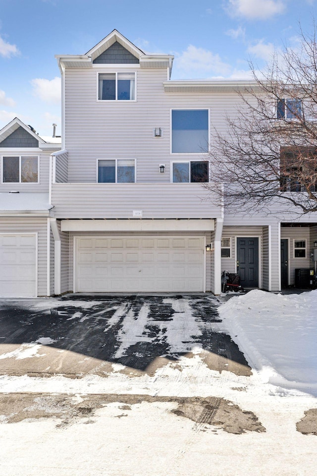 multi unit property featuring a garage and central AC