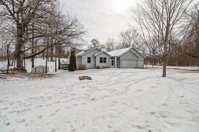 view of front of property featuring an attached garage and a shed