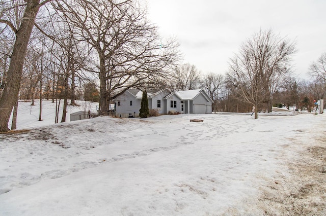 yard layered in snow with a garage