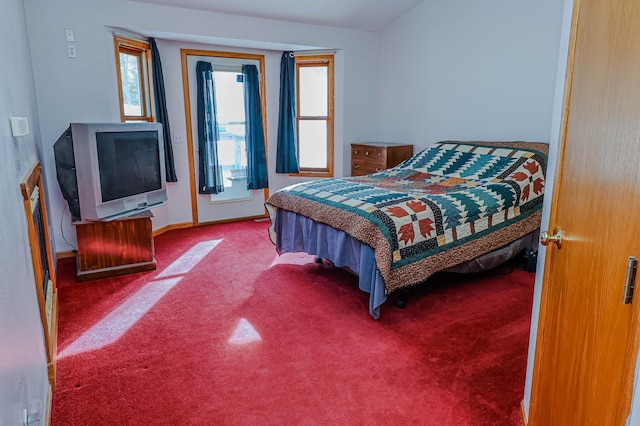 bedroom with access to exterior, carpet, and baseboards