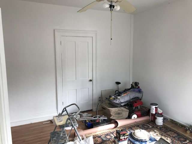 interior space featuring baseboards and wood finished floors