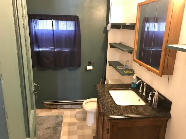 half bathroom featuring vanity, toilet, and tile patterned floors