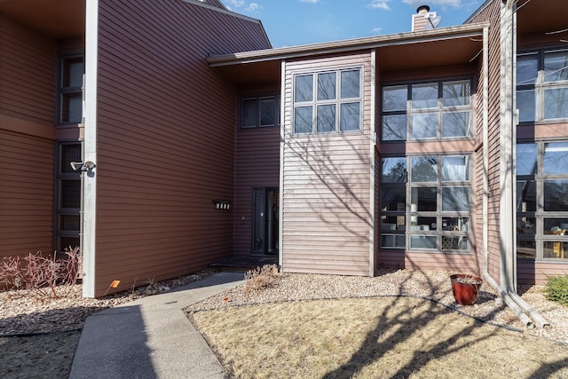 rear view of house featuring a chimney