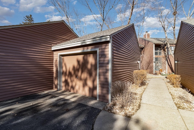 garage with aphalt driveway