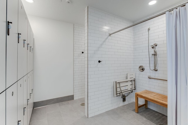 bathroom featuring tile patterned flooring, a tile shower, baseboards, and recessed lighting