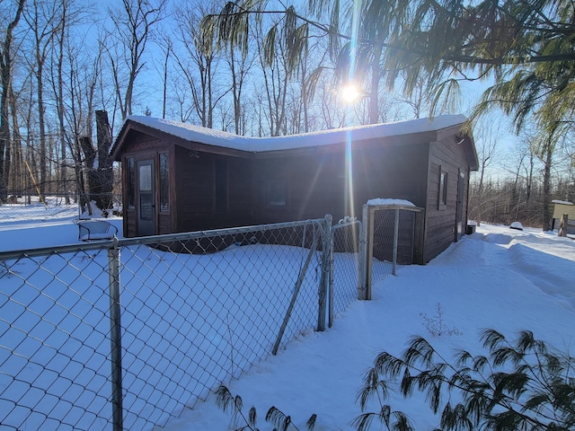 view of snow covered exterior featuring fence