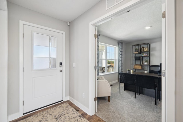 foyer with visible vents and baseboards