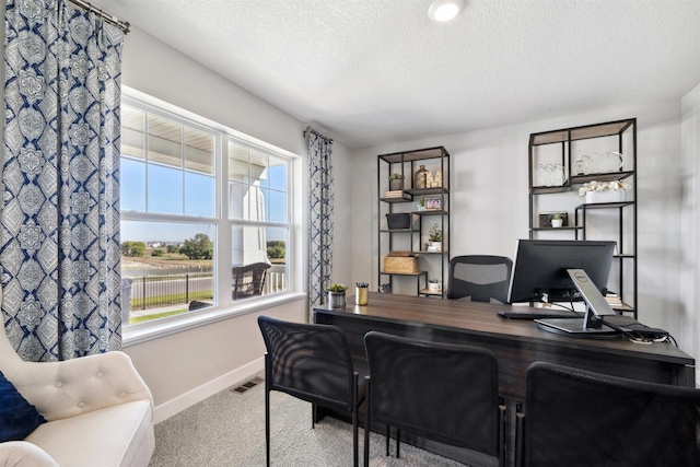 office area featuring baseboards, carpet, visible vents, and a textured ceiling