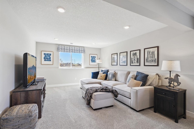 living room featuring a textured ceiling, baseboards, and light colored carpet