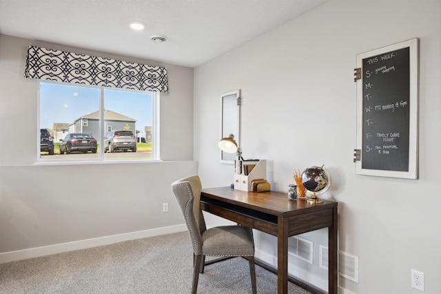 carpeted home office featuring baseboards