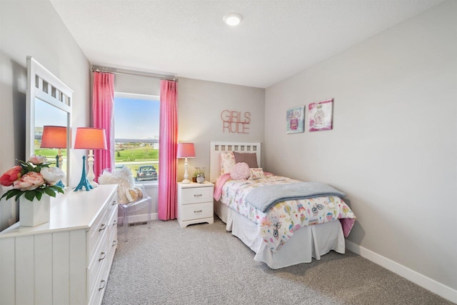 bedroom with light carpet and baseboards