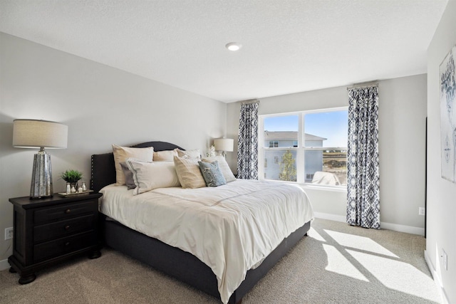 bedroom with light carpet and baseboards