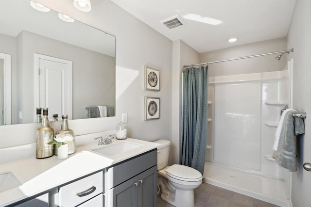 full bath with toilet, a stall shower, visible vents, and vanity