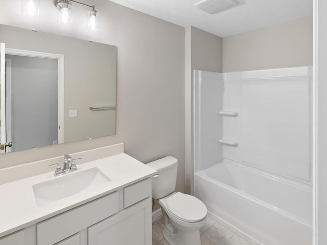 full bathroom with shower / washtub combination, visible vents, toilet, vanity, and tile patterned floors