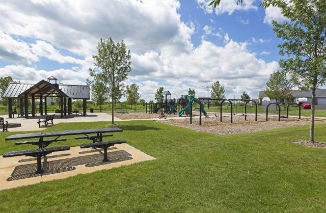 community playground featuring a lawn and a gazebo