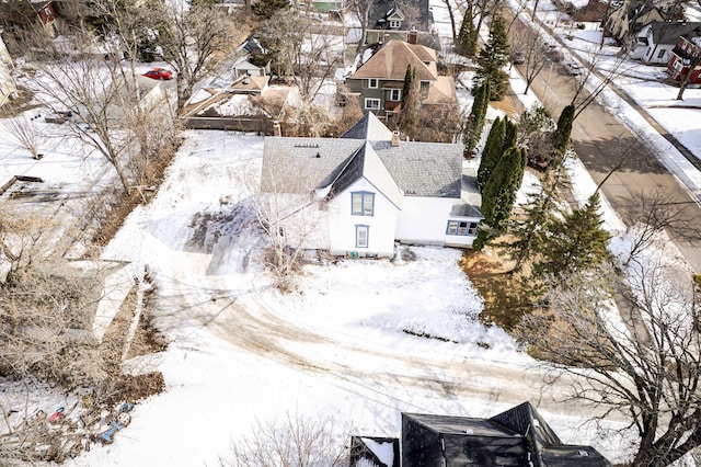 snowy aerial view with a residential view