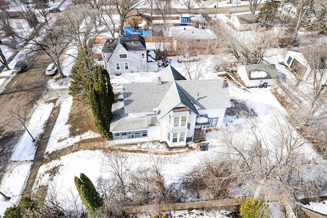 snowy aerial view with a residential view