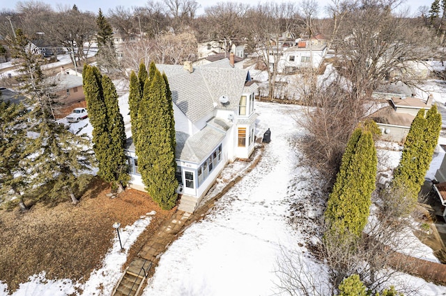 snowy aerial view with a residential view