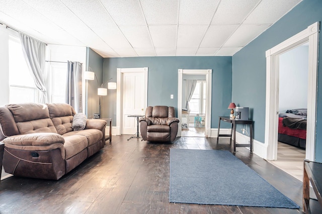 living area featuring baseboards and dark wood finished floors