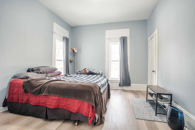 bedroom with baseboards and light wood-style floors