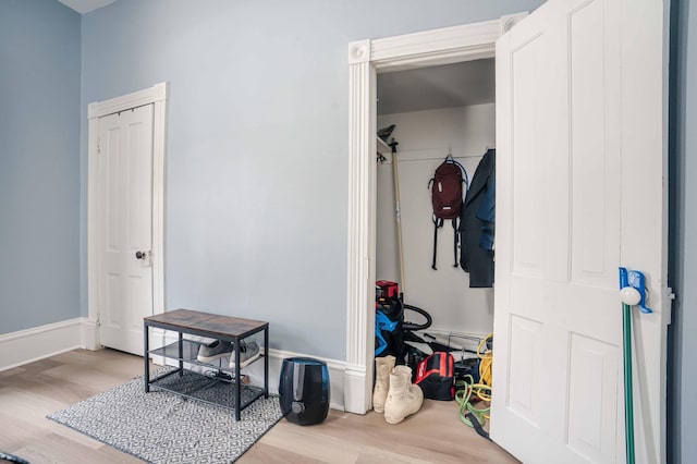 mudroom featuring baseboards and wood finished floors