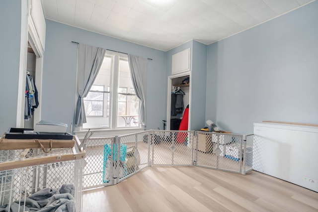 interior space with white cabinets and light wood-style flooring