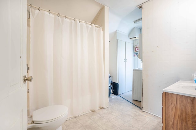 full bathroom with toilet, a shower with shower curtain, vanity, and tile walls