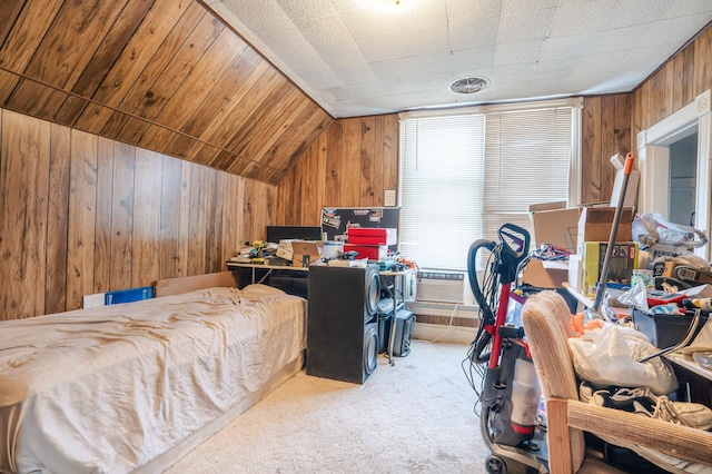 bedroom with lofted ceiling, light colored carpet, wood walls, and visible vents