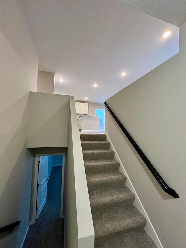 staircase featuring carpet, baseboards, and recessed lighting