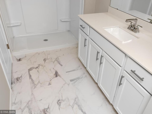 bathroom featuring a shower stall and vanity