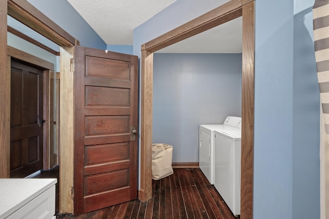 laundry area with baseboards, laundry area, separate washer and dryer, a textured ceiling, and wood-type flooring