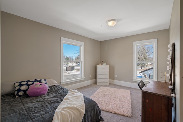 bedroom with baseboards and light colored carpet