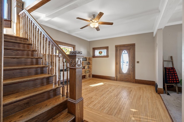 entryway featuring beamed ceiling, stairs, baseboards, and hardwood / wood-style floors