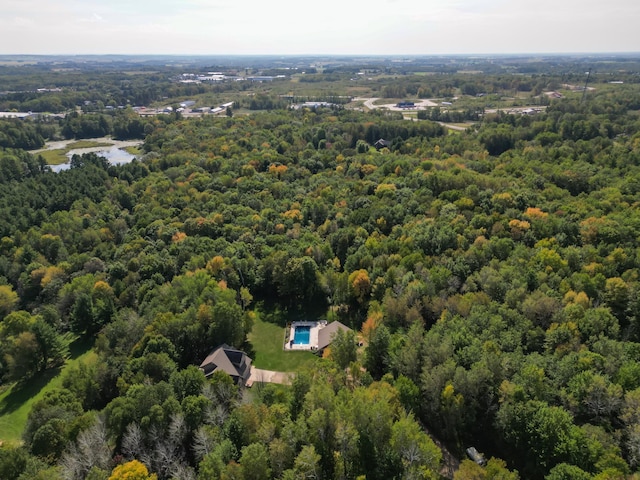 drone / aerial view featuring a forest view