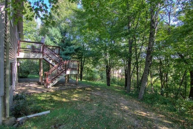 view of yard with stairway and a wooden deck