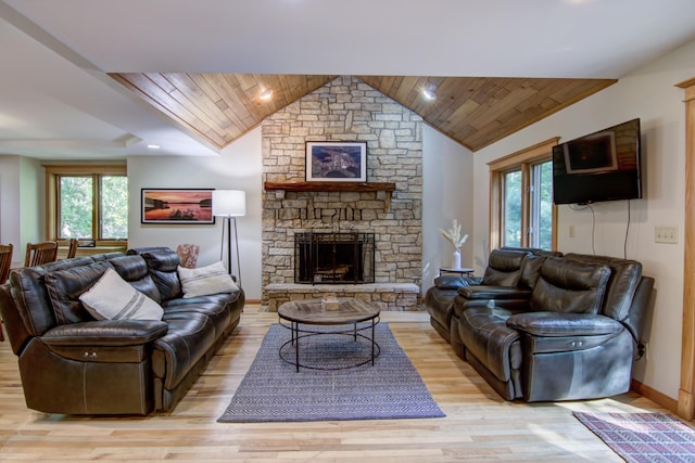 living room with a fireplace, lofted ceiling, light wood-style floors, wood ceiling, and baseboards