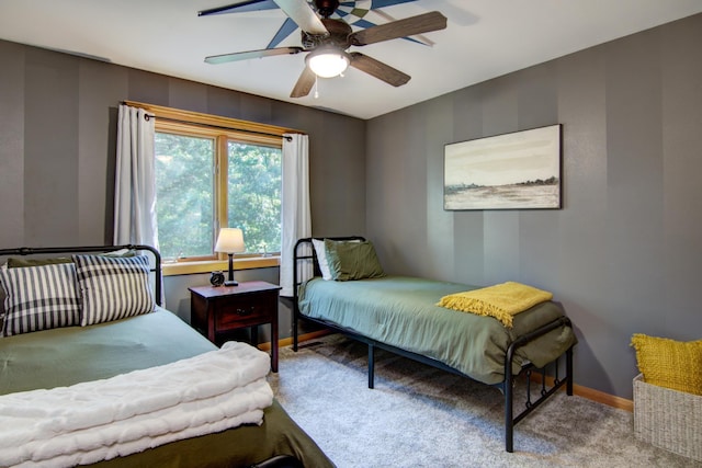 bedroom with light colored carpet, ceiling fan, and baseboards