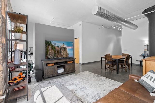 living room featuring concrete floors and baseboards