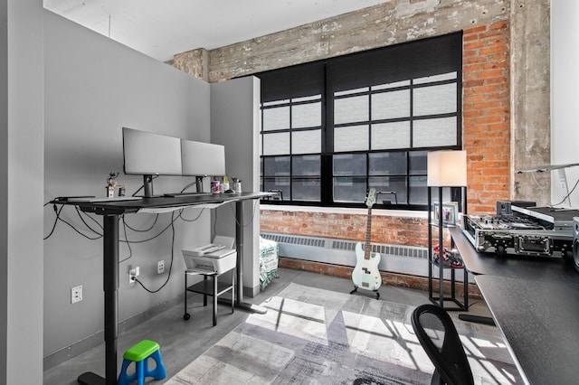 home office with finished concrete floors, radiator, brick wall, and baseboards